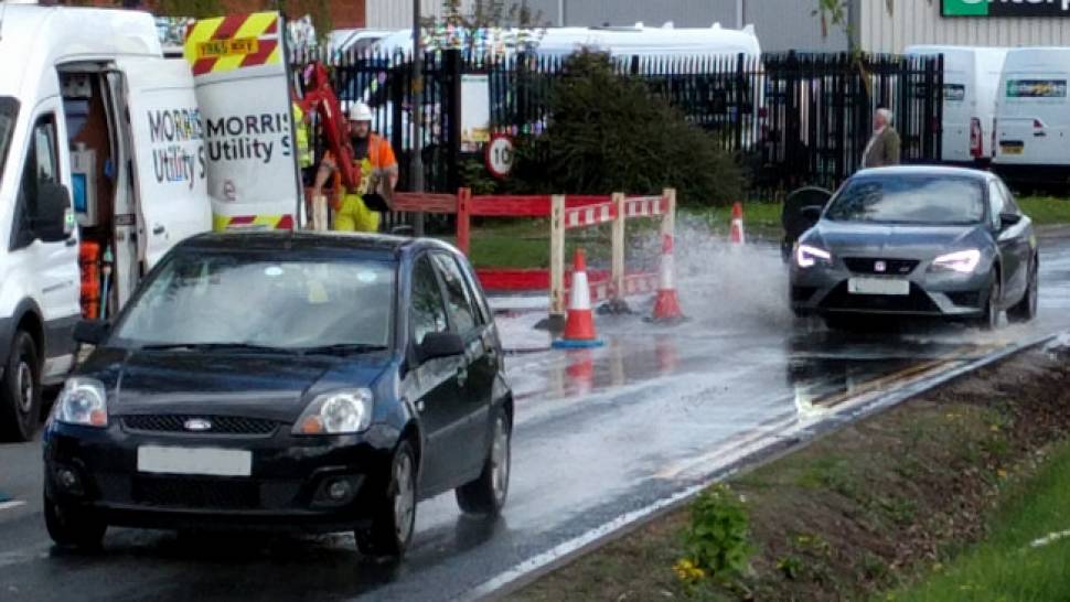 Cars passing through flooding on Canal Road